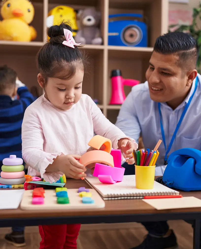 The holder of a graduiate diploma in Early Childhood Teaching at work, facilitating learning and play for their students.